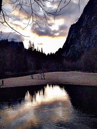 Scenic view of river against cloudy sky