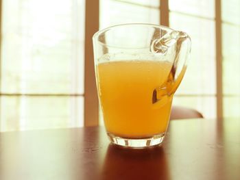 Close-up of orange juice on table