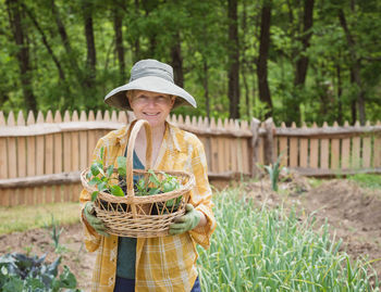 Portrait of smiling woman holding basket