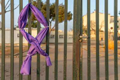 Close-up of clothes hanging on fence