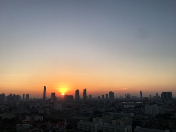 Cityscape against sky during sunset