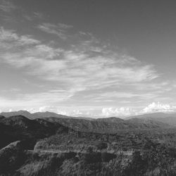 Scenic view of mountains against cloudy sky