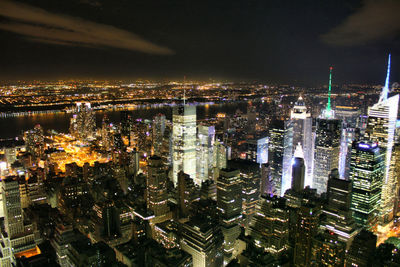 High angle view of city lit up at night