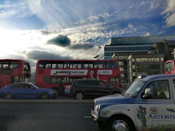 Vehicles on road against buildings in city