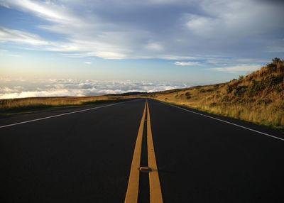 Empty road along countryside landscape