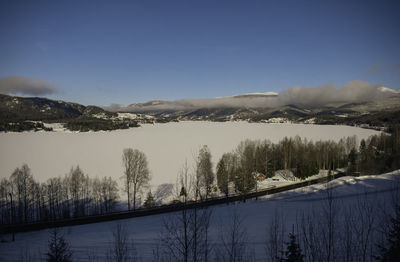 Scenic view of lake and mountains against sky