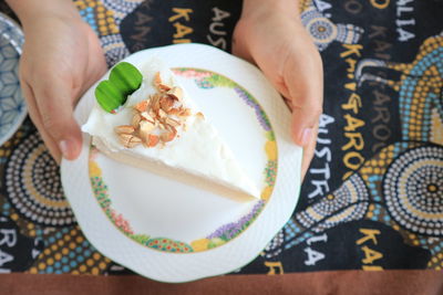 Midsection of woman holding ice cream in plate