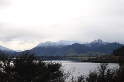 Scenic view of lake and mountains against sky