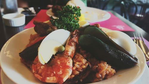 Close-up of paella served in plate on table