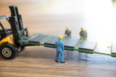 Close-up of figurines with ram at table