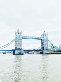 View of bridge over river with city in background