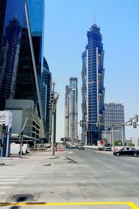 View of city street and buildings against sky