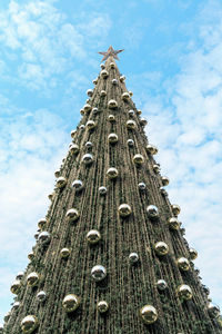 Outdoor christmas tree at daytime with beautiful blue sky