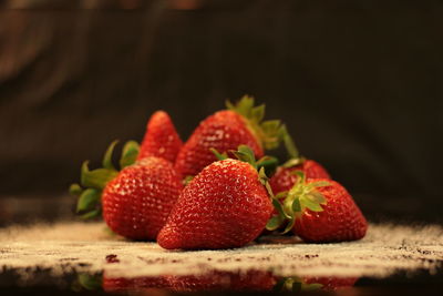 Close-up of strawberries with powder sugar on table