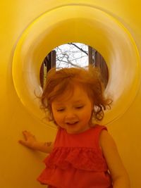 Close-up of cute girl playing in slide