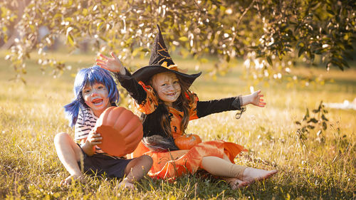 Boy and girl in carnival costumes celebrate halloween