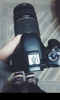 Close-up of man photographing camera