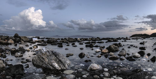 Rocks on beach against sky