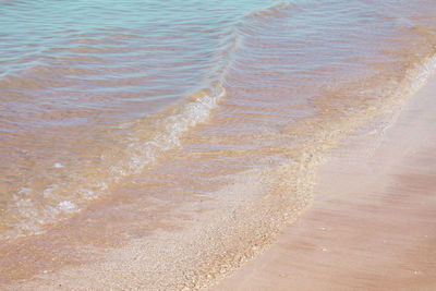 High angle view of waves rushing towards shore