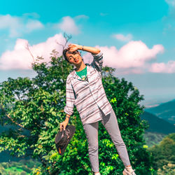 Woman standing against plants against sky