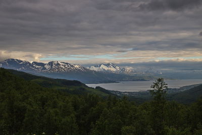 Scenic view of snowcapped mountains against sky during sunset