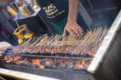 Man preparing food on barbecue grill