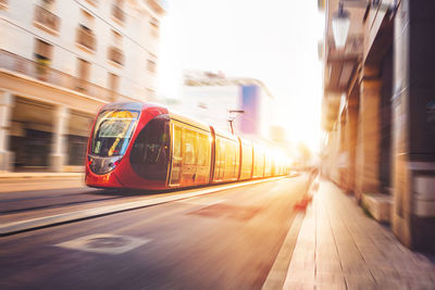 Blurred motion of train in city against sky