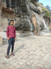 Portrait of woman standing on rock