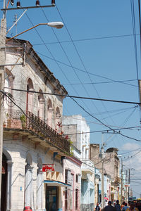Residential street in camaguey, cuba. an excessof power lines.