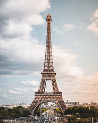 Tower of building against cloudy sky