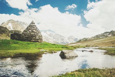 Scenic view of landscape against cloudy sky