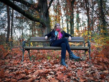 Side view of woman sitting in park