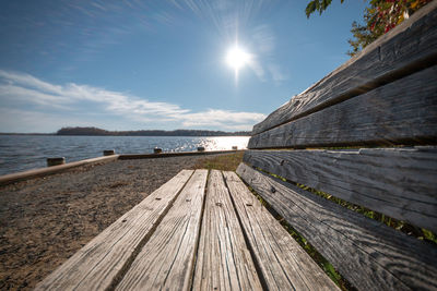 Surface level of footpath by sea against sky