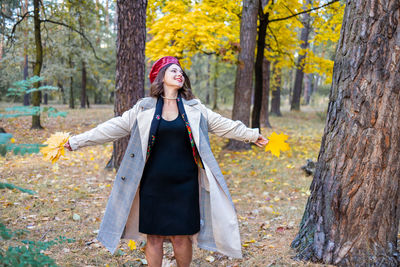 Portrait of woman standing in forest