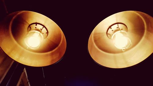 Close-up of illuminated light bulb on table