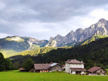 Houses by mountains against sky