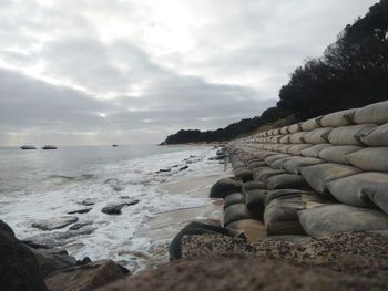 Rocks on beach against sky