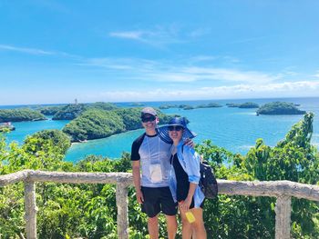 Couple standing against sea at observation point