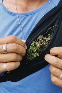 Midsection of woman holding flower