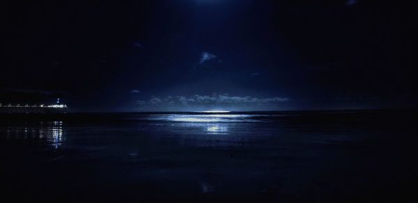 Scenic view of sea against sky at night