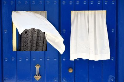 White curtains on blue wooden door