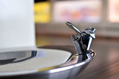 Close-up of faucet in container at home