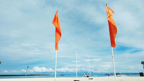 Flag on sea against sky