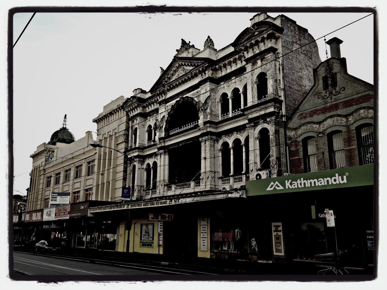 transfer print, architecture, building exterior, built structure, auto post production filter, low angle view, city, clear sky, travel destinations, sky, human representation, history, incidental people, day, outdoors, building, travel, facade, famous place, street