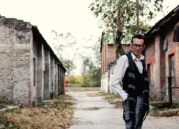 Portrait of vintage styled confident man with hands in pockets standing outdoors.