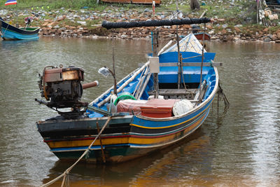 Boats moored in river