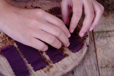 Close-up of woman preparing food on wood