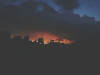 Buildings against sky at sunset