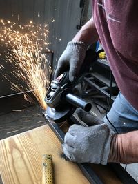 Midsection of man working in factory