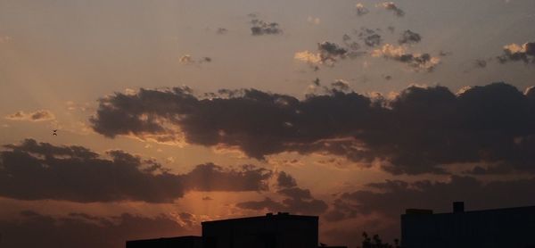 Low angle view of silhouette buildings against sky during sunset